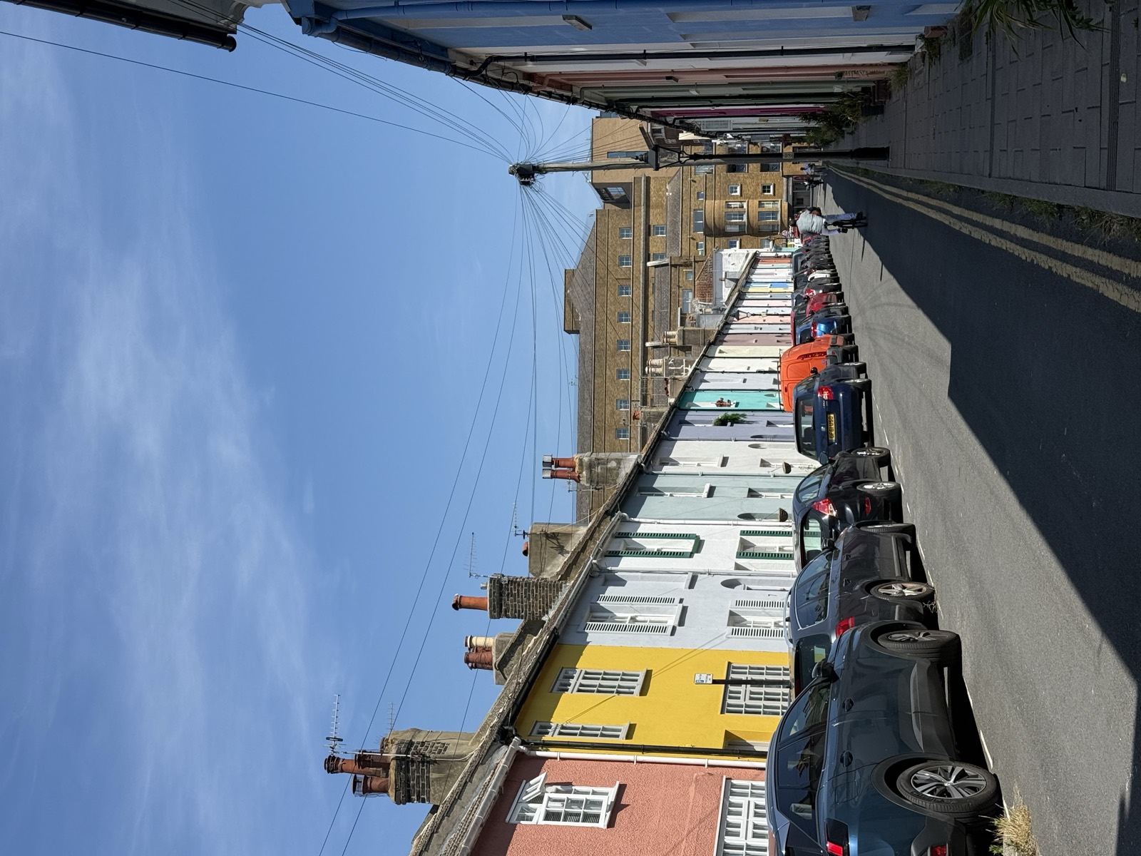Pastel-painted terraced houses on a Brighton back street near The Lanes